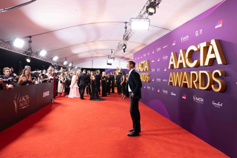 People are gathered on the red carpet at the AACTA Awards, with photographers capturing the event.